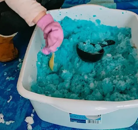 colored snow sensory bin for toddlers 