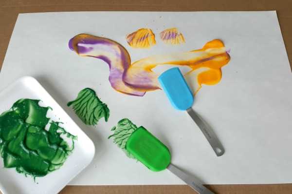 toddler painting using spatulas process art