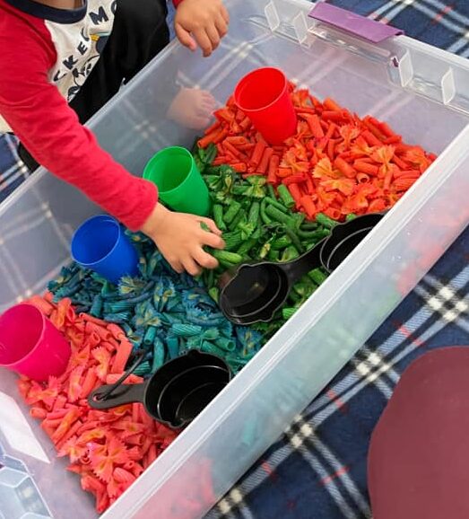 colored pasta sensory bin 