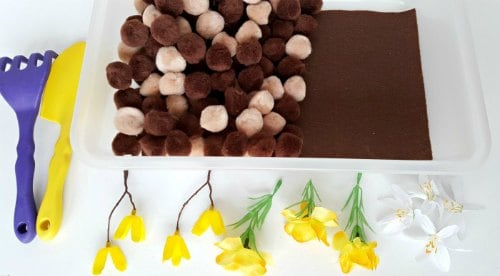 how to set up a spring flowers and pompoms sensory bin activity