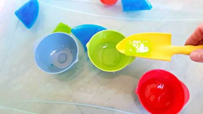 scooping up ice shapes with water tools