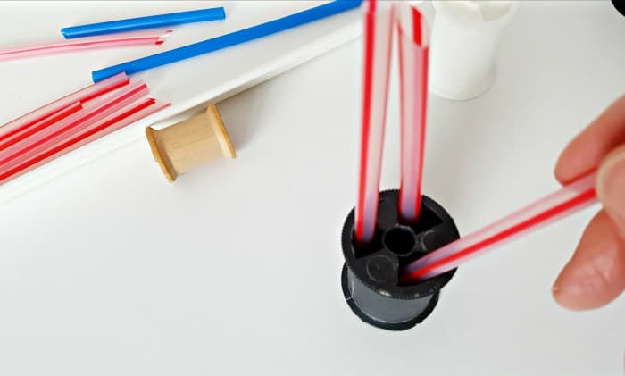 toddler fine motor activity with straws and spools