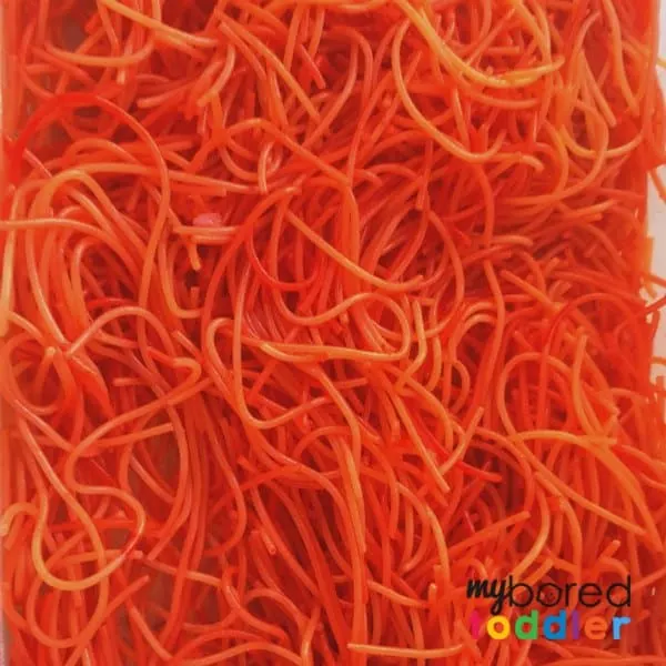 Colored spaghetti for sensory play