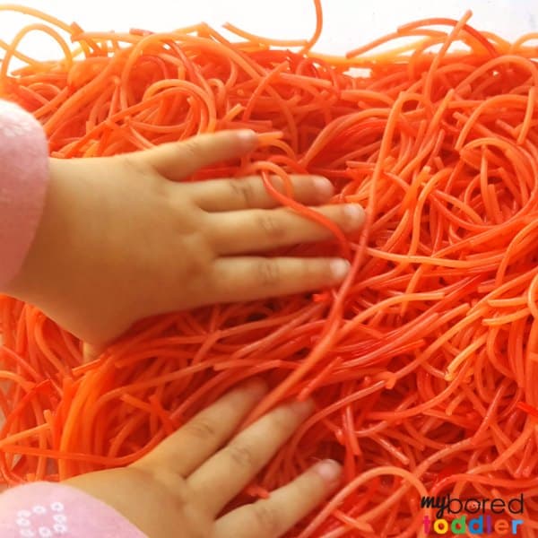 Making colored spaghetti for messy play and sensory bins