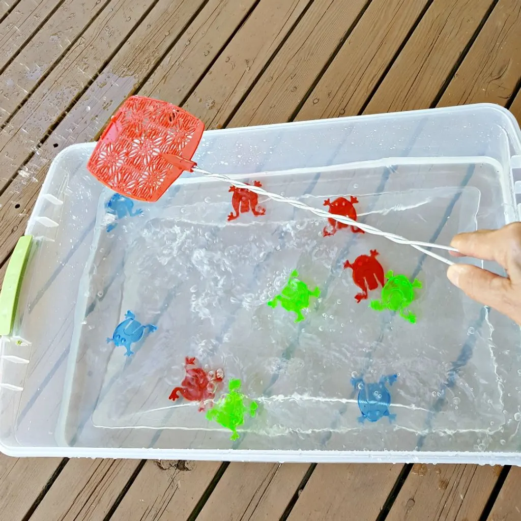 water play activity with a fly swatter