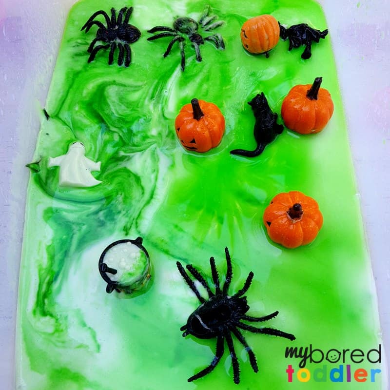 Halloween science fizzing sensory bin for toddlers pumpkins and spiders