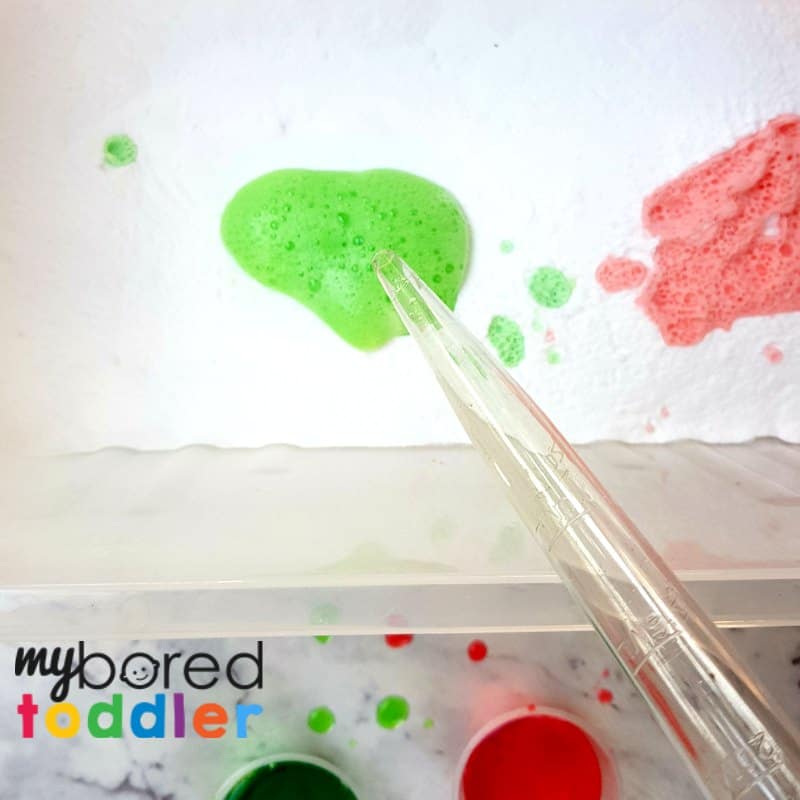 colorful fizzing sensory bin with vinegar and baking soda