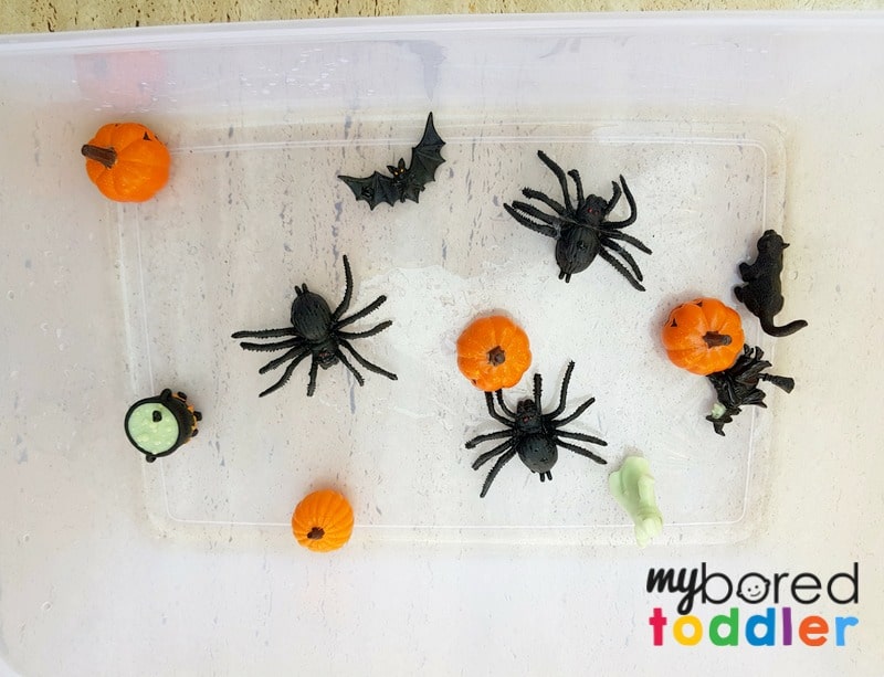 halloween fizzing science sensory bin baking soda and vinegar spiders pumpkins setup 1