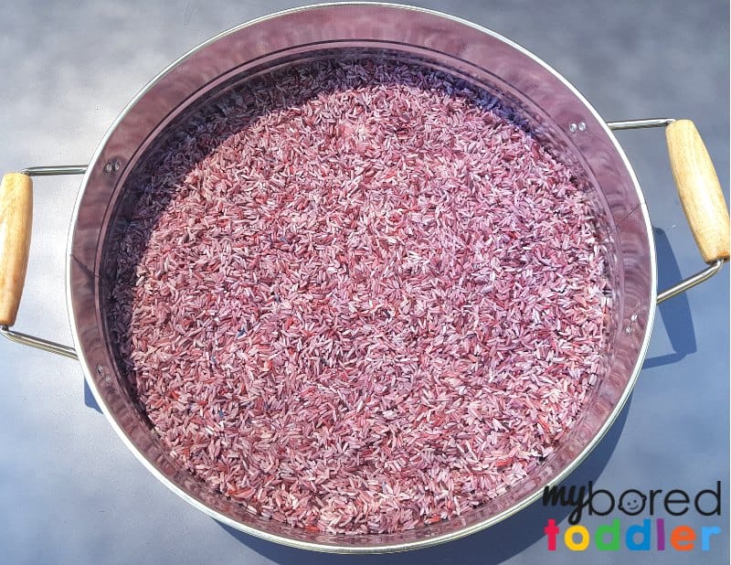 How to make colored rice for a Halloween rice sensory bin step 2 in the container