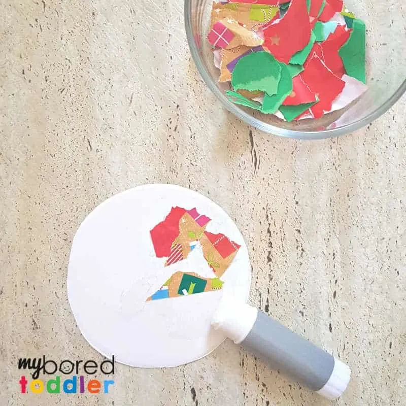 easy christmas ornament for toddler gluing the paper on