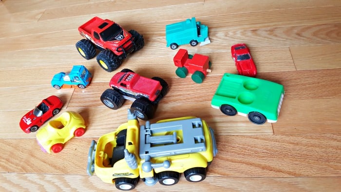 Toy cars and trucks can be used for a color sorting activity with toddlers