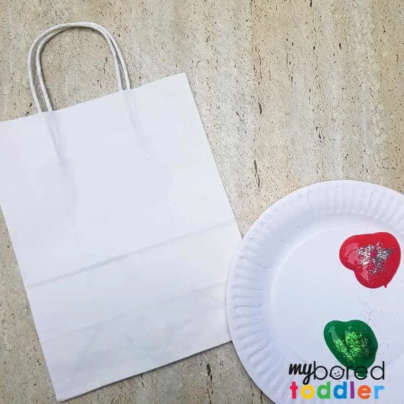 stamped gift bag craft for toddlers and preschoolers setting up the paint