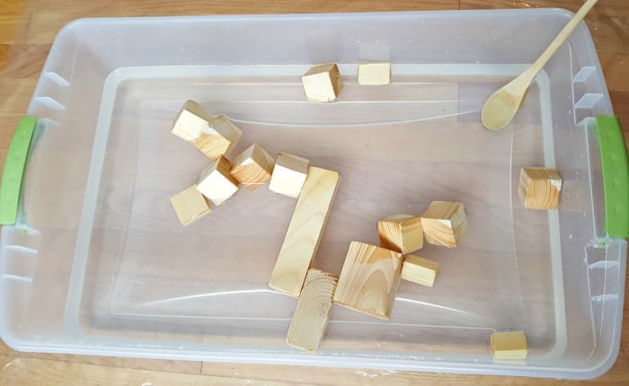 Add small wood blocks and wooden spoon to water bin
