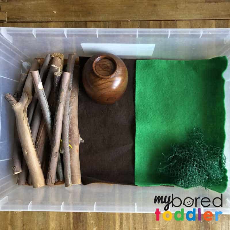 setting up for a sensory wood pile small world play for toddlers 3