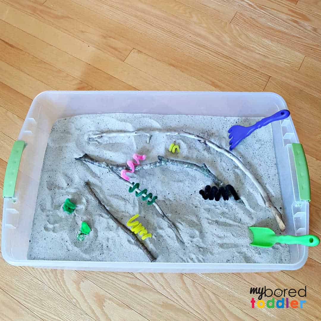 Sandbox summer sensory play with kid-made caterpillars