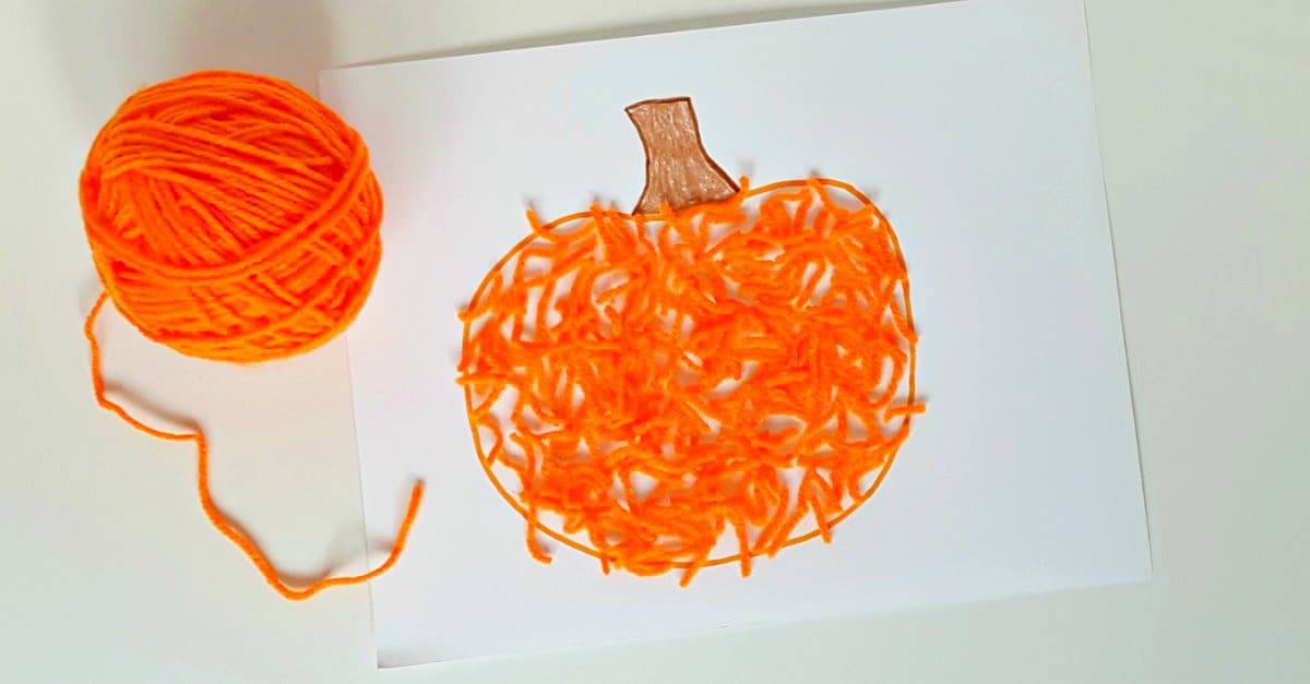 Fall pumpkin toddler craft with orange yarn
