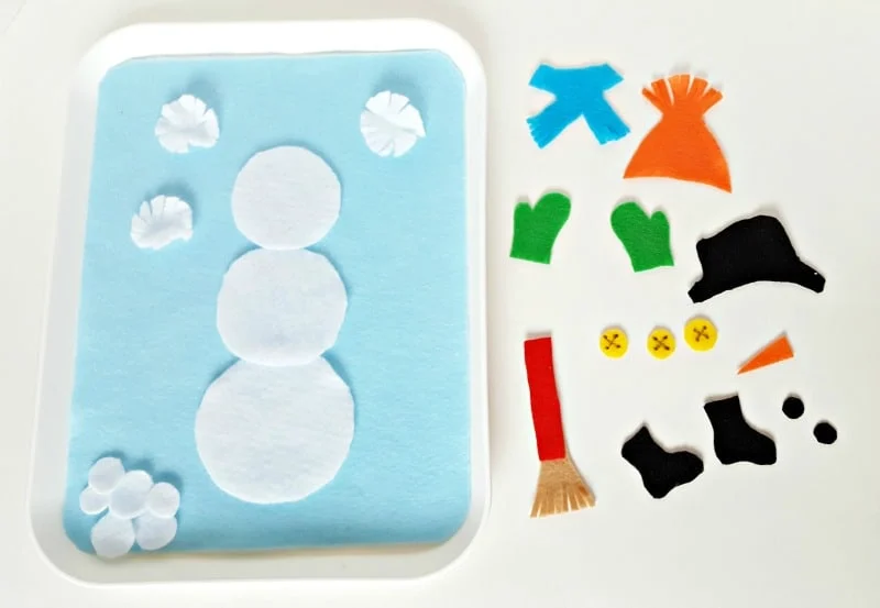 Felt cut outs can be added to a felt snowman for a winter theme toddler activity