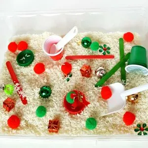 Toddler holiday sensory bin with rice and pompoms - My Bored Toddler