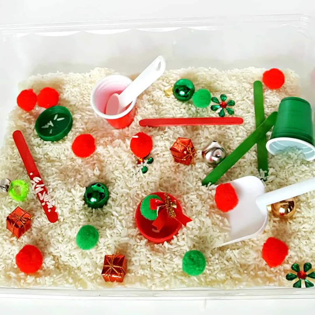 Toddler holiday sensory bin with rice and pompoms