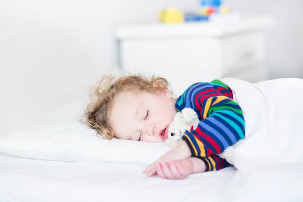 Adorable toddler girl taking a nap in a white bed My Bored Toddler