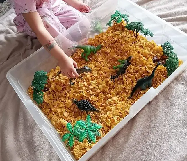 @just_jska cornflakes and dinos sensory bin idea for toddlers 