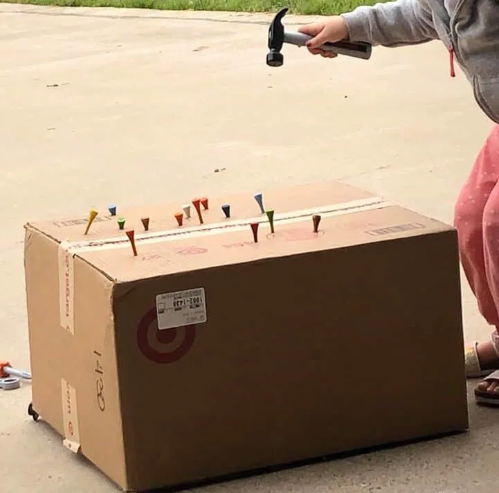 golf tees and a cardboard box 