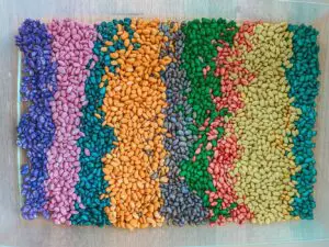 colored beans in a plastic tub