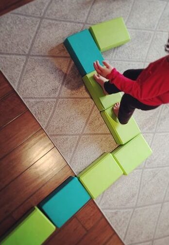 using yoga blocks as a toddler balancing activiy 