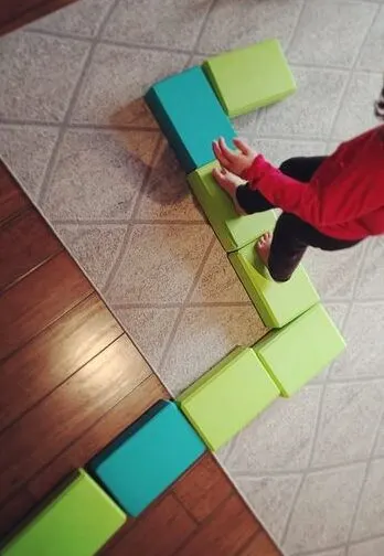 using yoga blocks as a toddler balancing activiy 